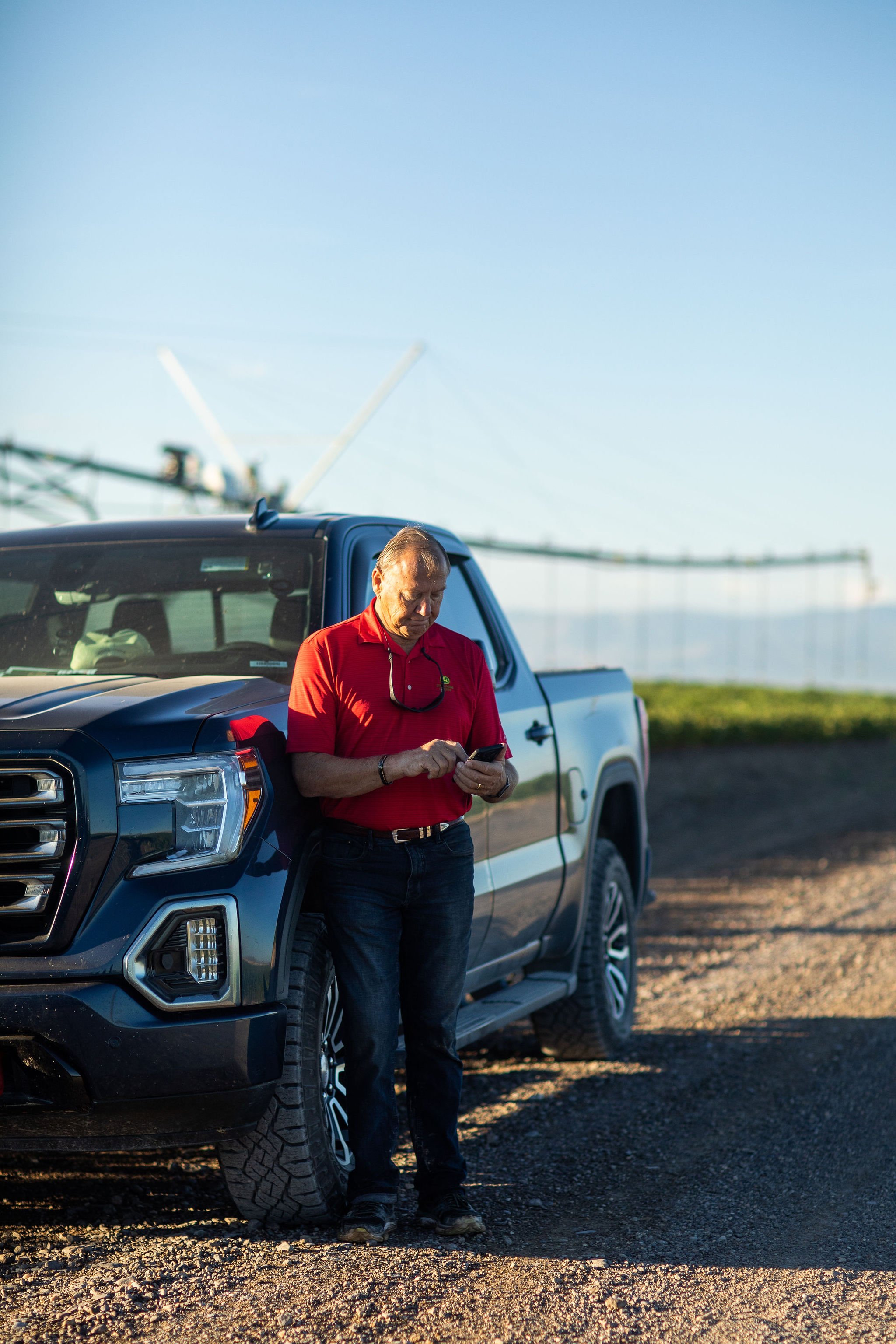 Grower logging spray records from the field next to his truck